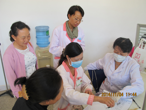国家卫生计生委陈医生对育龄群众进行问诊,当地计生服务站医务人员从旁学习.jpg